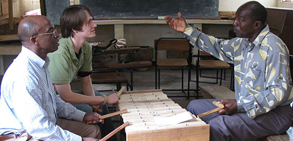 Mr. Ssebuwufu (on the right) elaborates on a Madinda stylistic technique to Kyle Prifogle '09 and Prof. Makubuya during the Summer '08 Field research in Uganda.