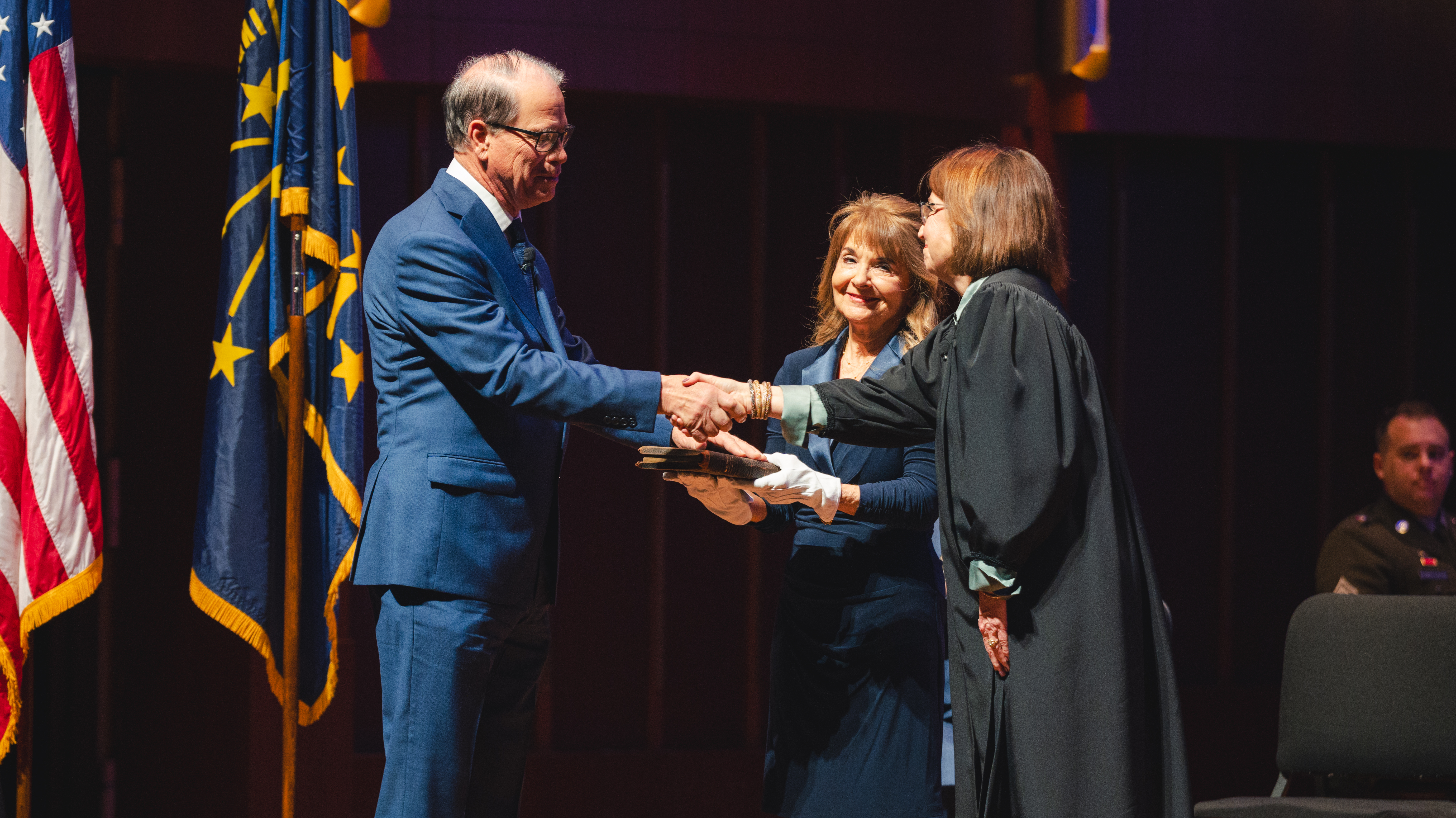 On both a family Bible and Hoosier President Benjamin Harrison’s inaugural Bible, Mike Braun ’76 took the oath of office January 13, 2025, at the Hilbert Circle Theatre in Indianapolis. Photo courtesy of Maverix Media 