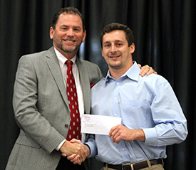 Dean Raters '85 (left) presents Grant Klembara with the Sparks Award.