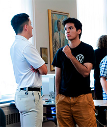 Julio Cruz-Romero '28 (right) chats with Cristian Cantu '26 at the listening party. 