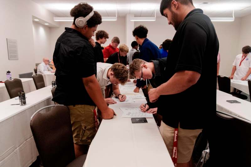 a group of people signing papers