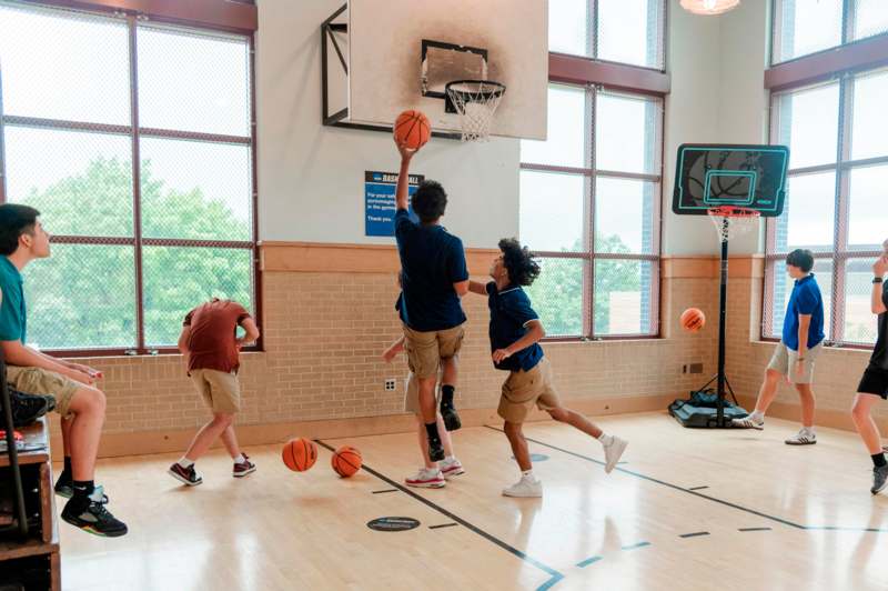 a group of people playing basketball