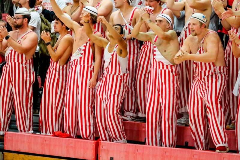 a group of people in striped overalls