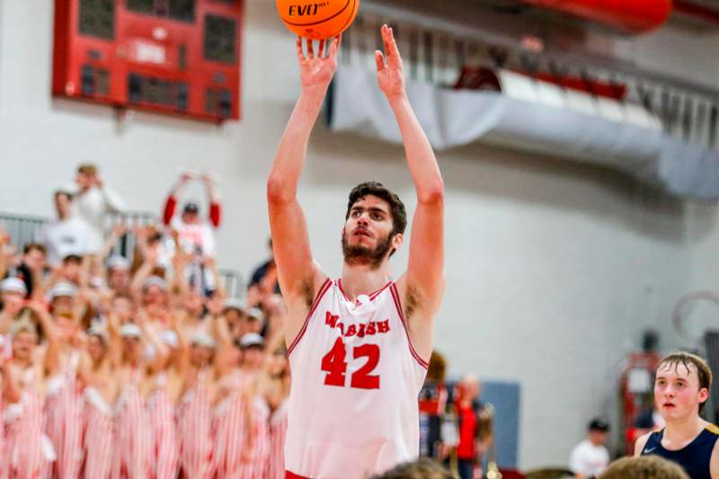 a man in a basketball jersey with a ball in his hand