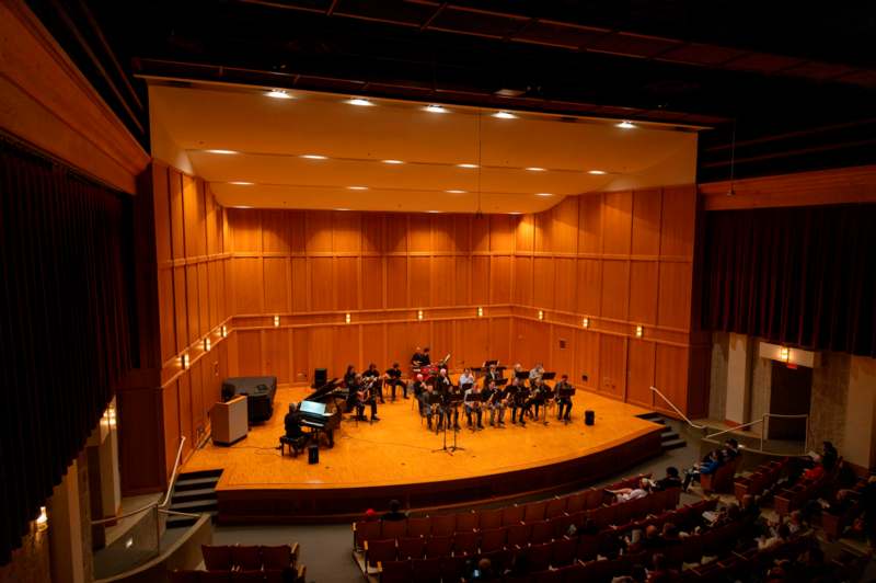 a group of people on a stage with instruments