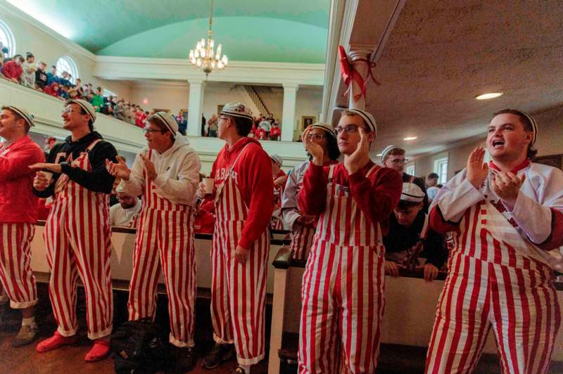 a group of people in striped overalls