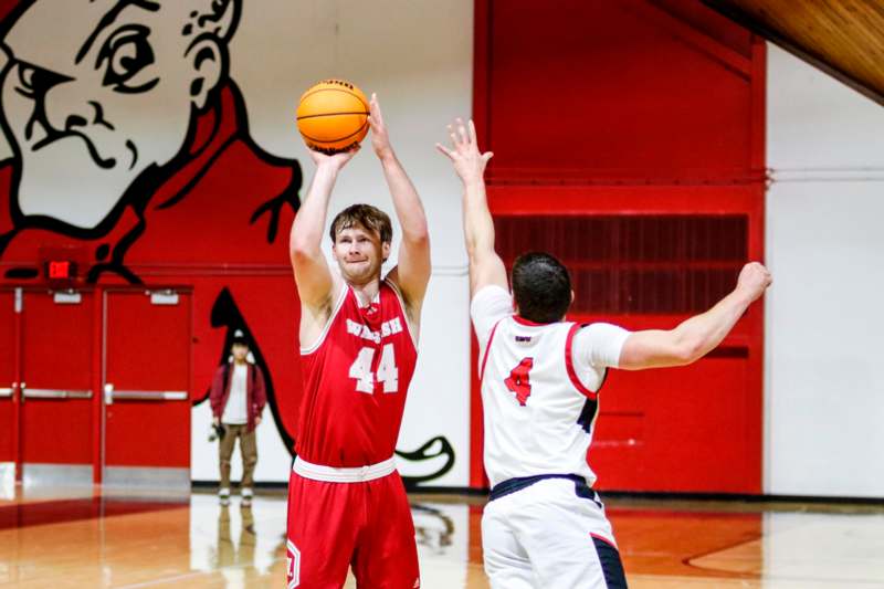 a basketball player in a red uniform with a ball in his hand