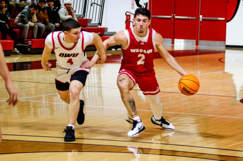 two men playing basketball on a court