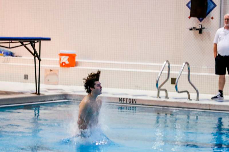 a man jumping into a pool