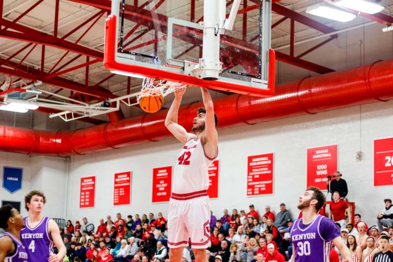 a basketball player dunking a basketball in a gym