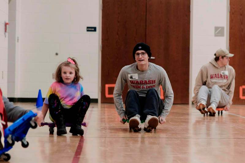 a group of people riding on small skateboards