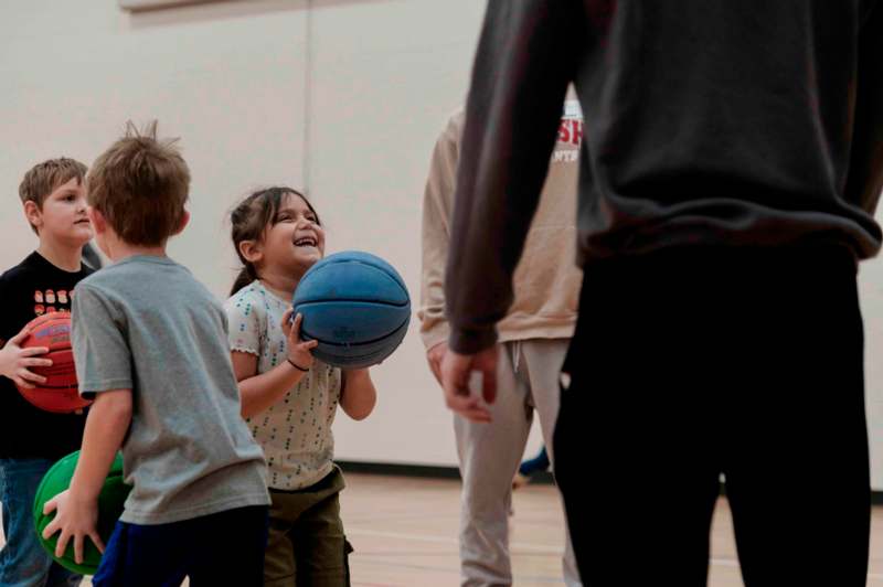 a girl holding a ball in a gym