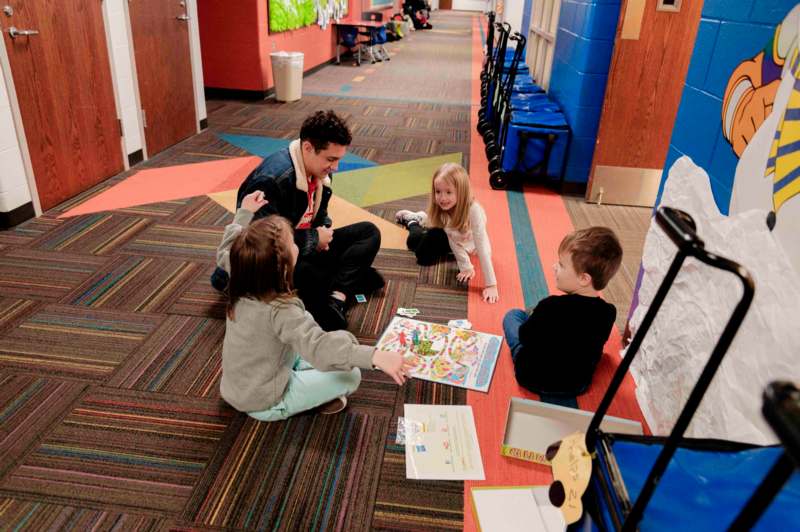 a man and children sitting on the floor