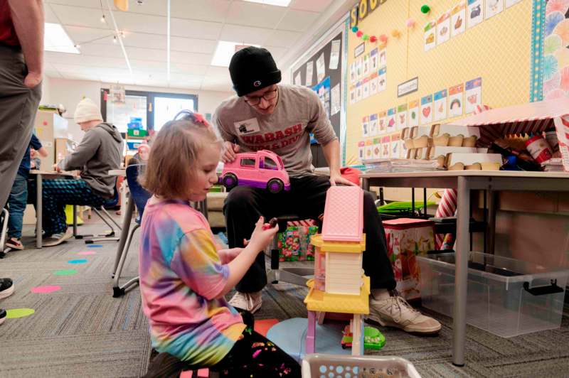 a man and a girl playing with toys