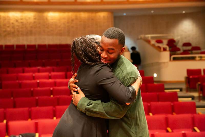 a man and woman hugging in a theater