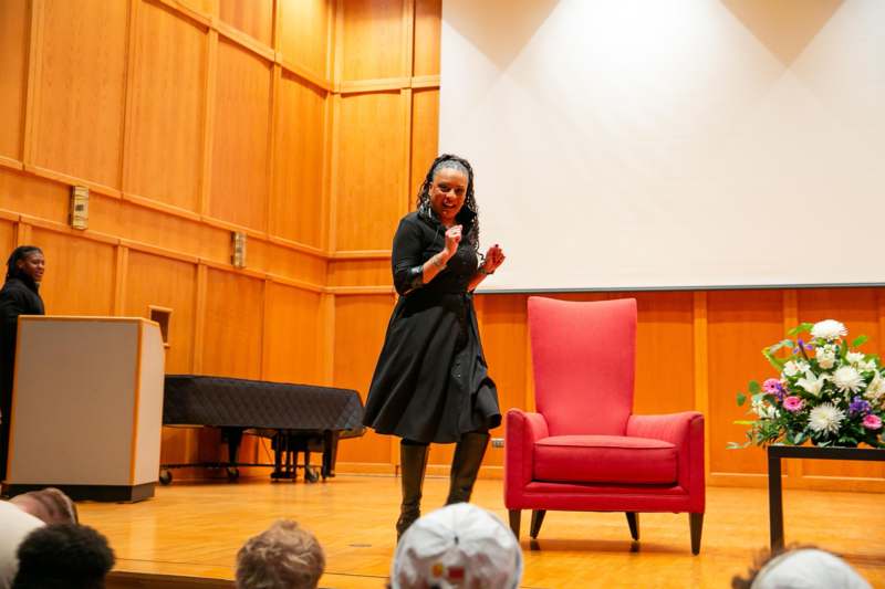 a woman in a black dress on a stage