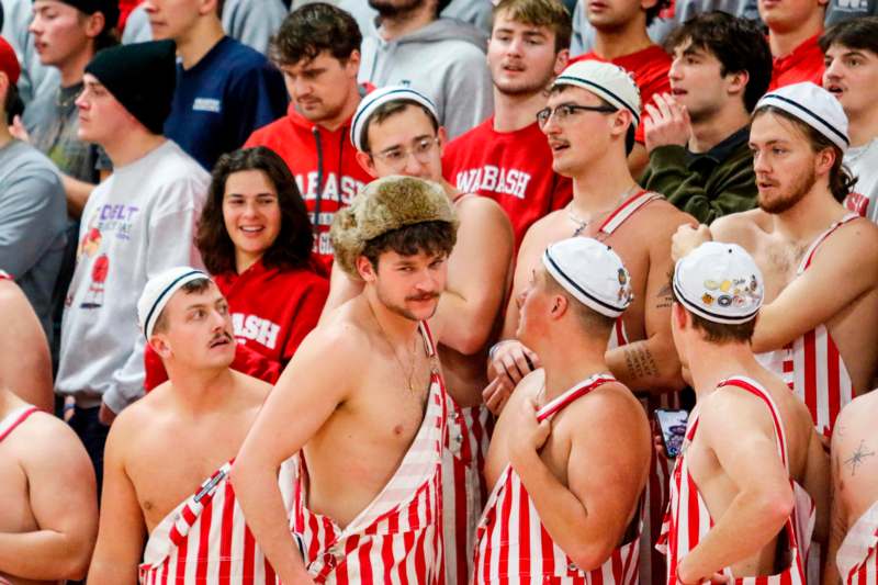 a group of people in red and white striped overalls