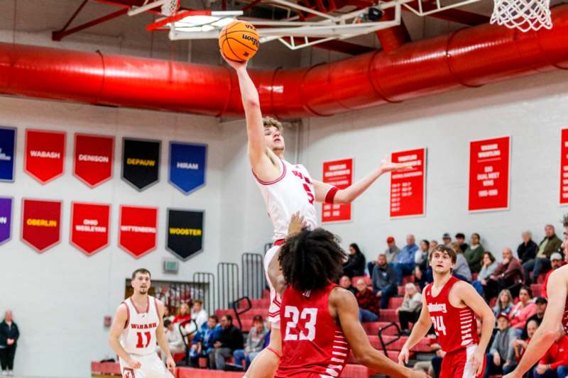 a basketball player jumping to shoot a basketball