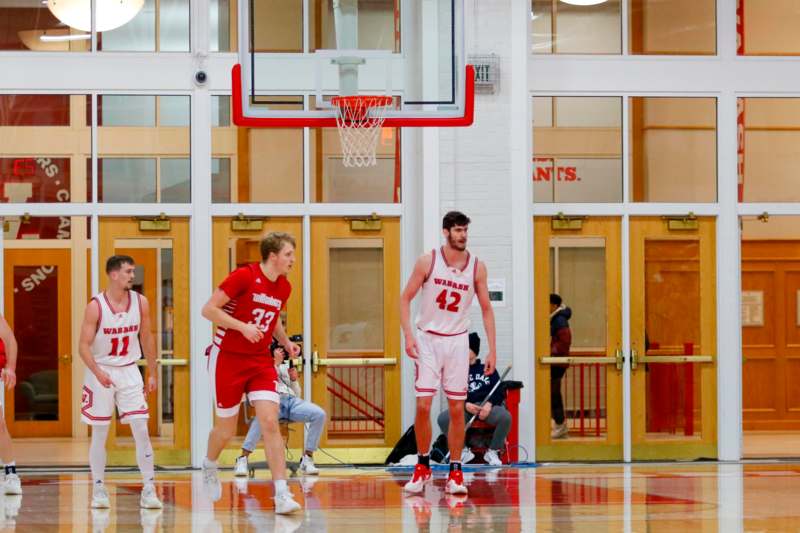 a group of men playing basketball