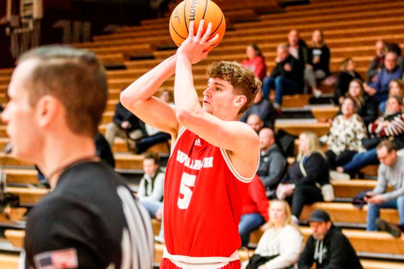 a man in a basketball uniform with a ball in his hands