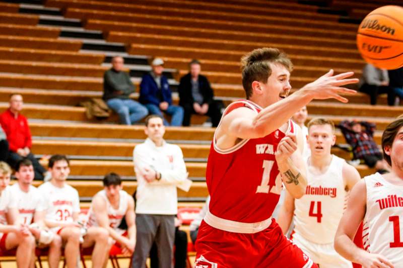 a man in a red uniform playing basketball