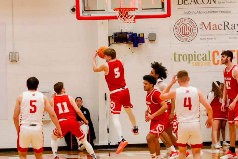 a group of people playing basketball