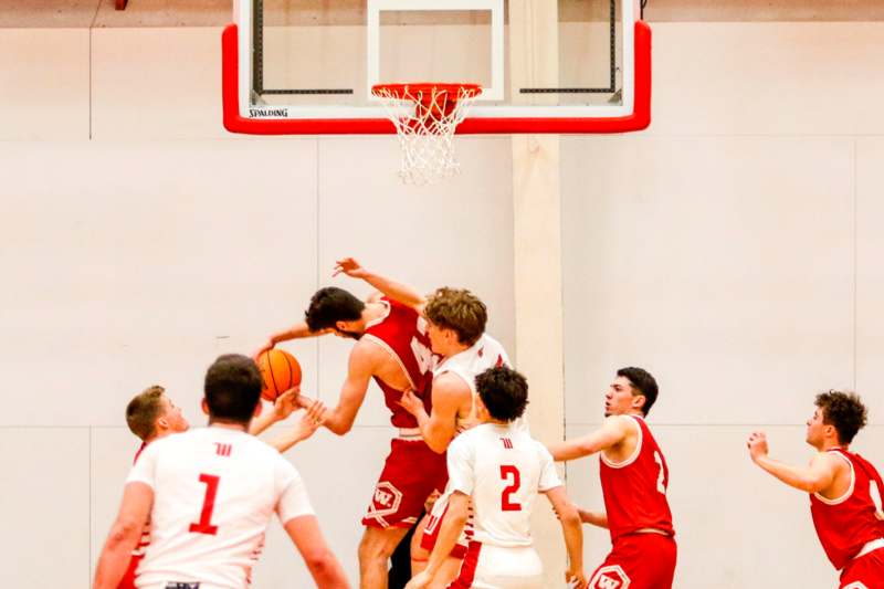 a group of men playing basketball