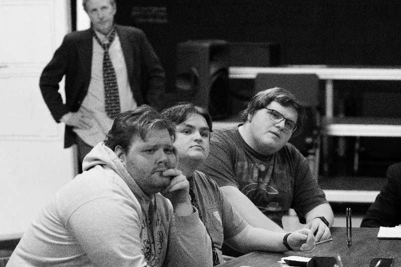 a group of men sitting at a table