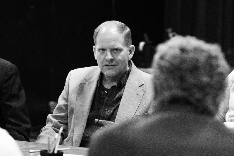 a man in a suit sitting at a table