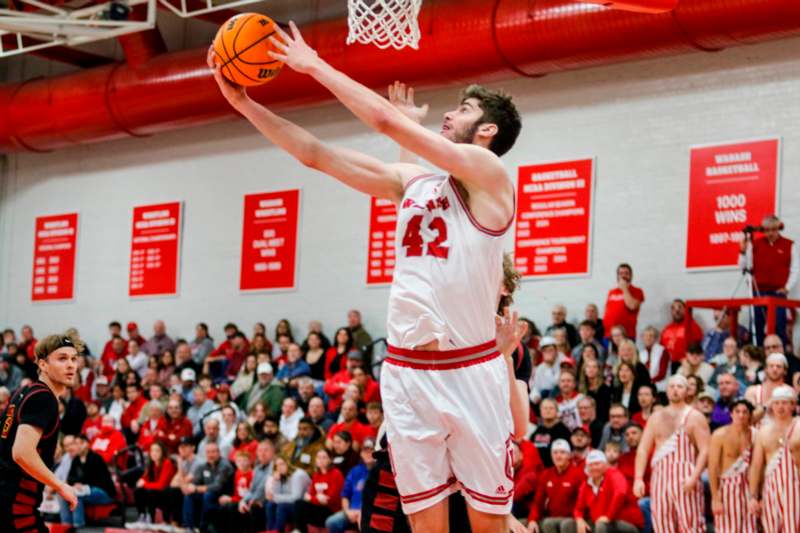 a basketball player dunking a ball