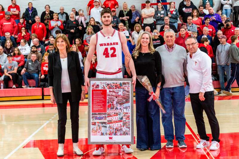 a group of people standing in front of a basketball court