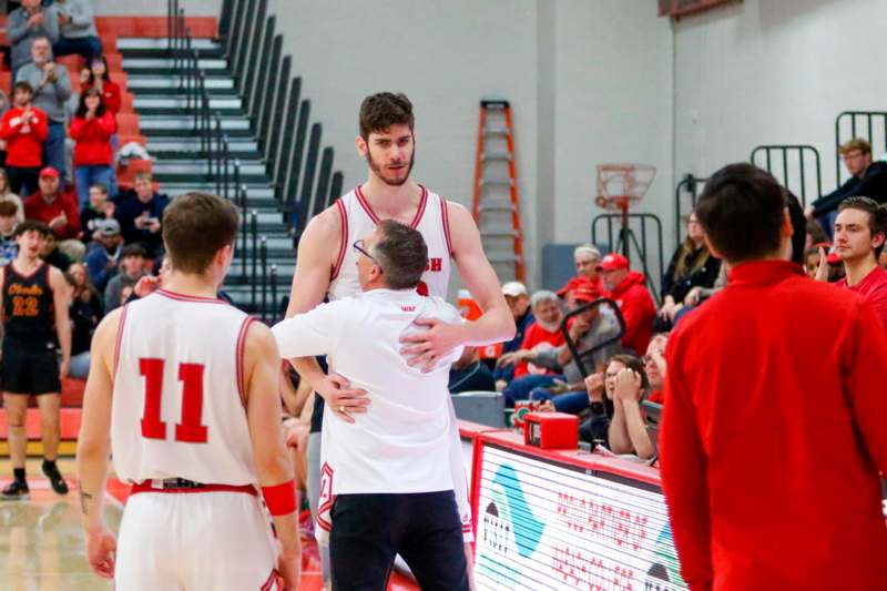 a basketball player hugging another player