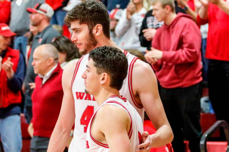 two men in basketball uniforms