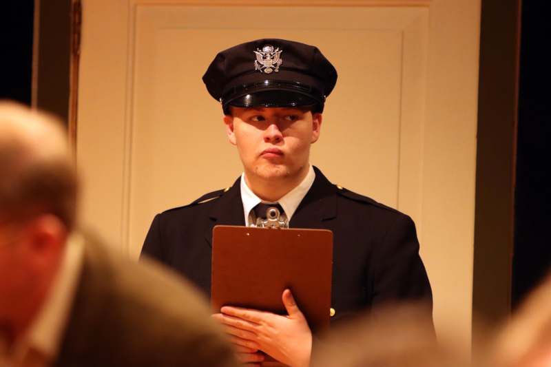 a man in uniform holding a clipboard