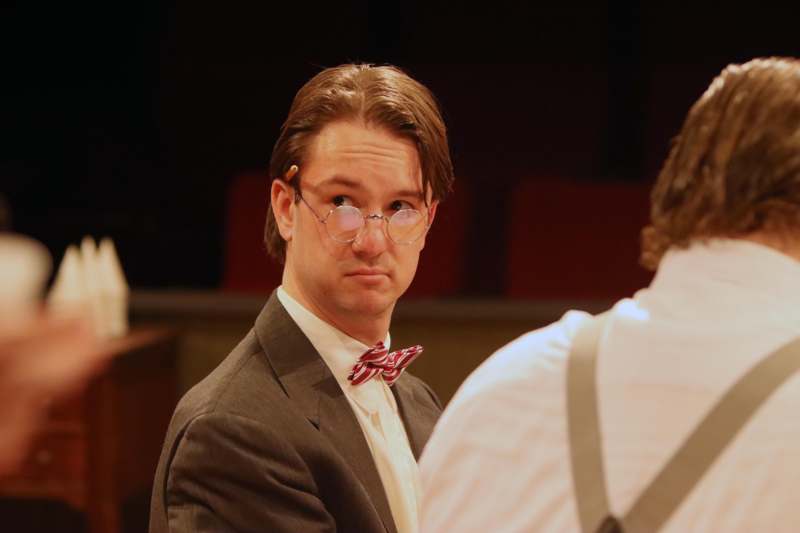 a man in a suit and bow tie