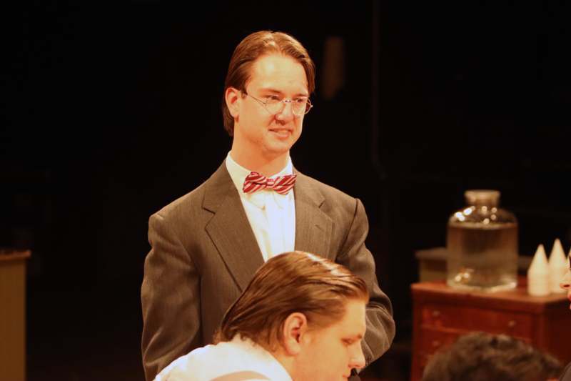 a man in a suit and bow tie