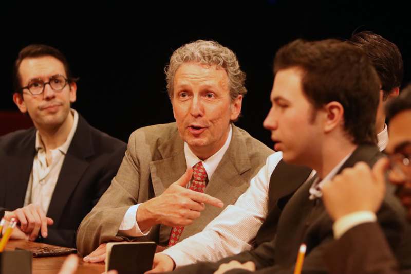 a group of men sitting at a table