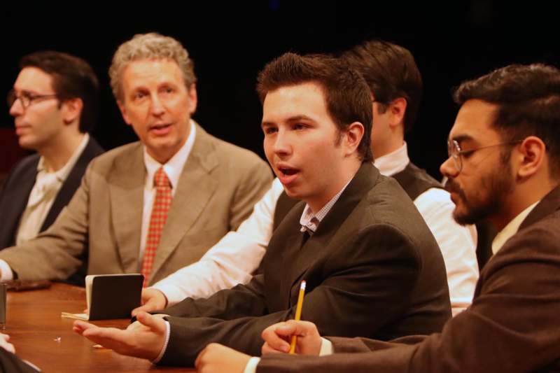 a group of men sitting at a table