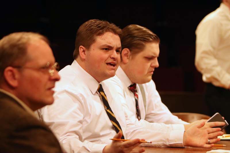 a group of men sitting at a table