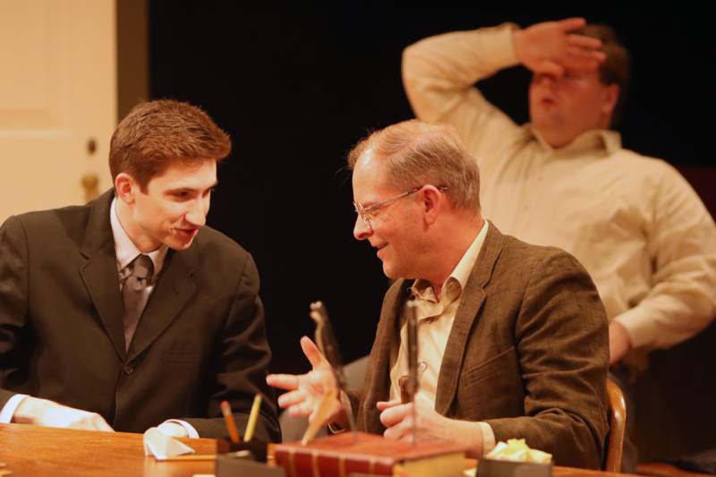 a group of men sitting at a table