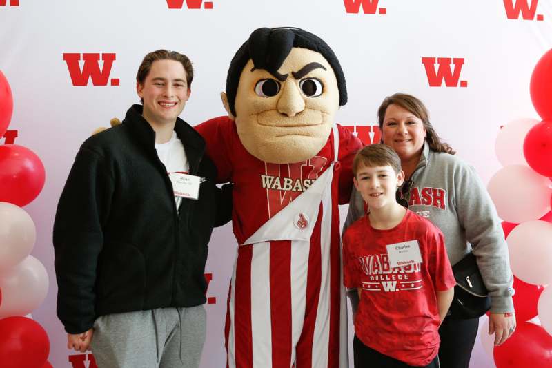 a group of people posing with a mascot