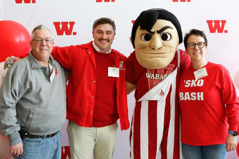 a group of people posing with a mascot