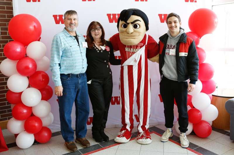 a group of people posing with a mascot