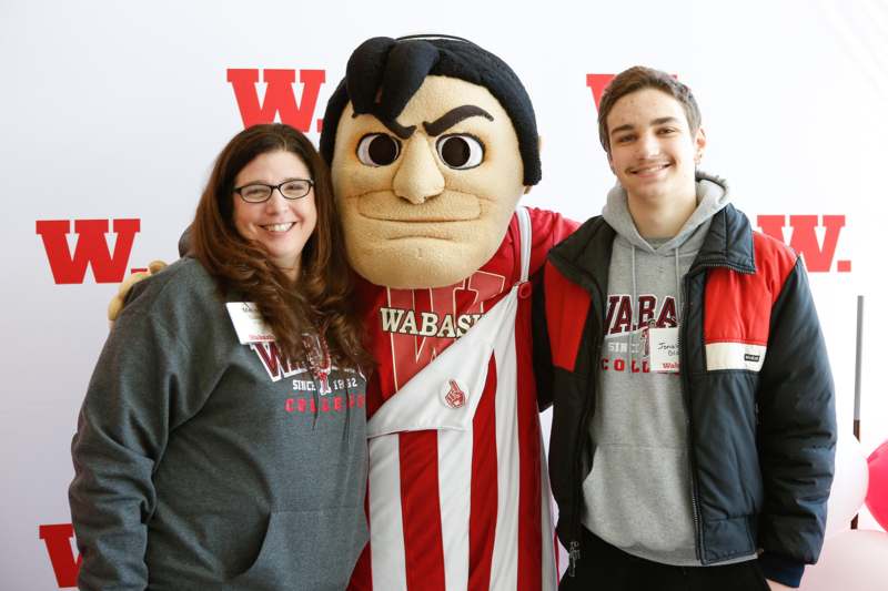 a group of people posing with a mascot