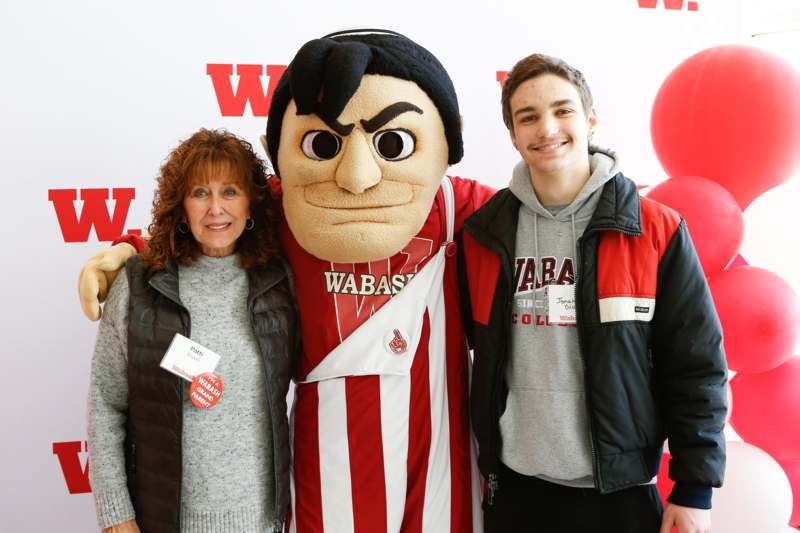 a woman standing next to a person in a mascot garment