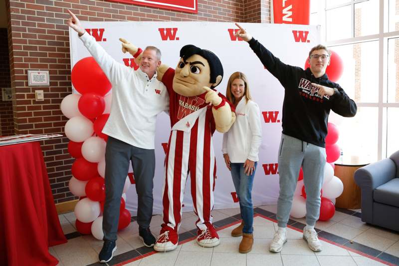 a group of people posing with a mascot