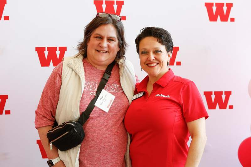 two women standing together smiling