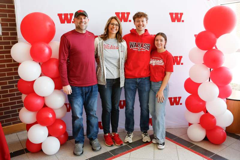 a group of people standing in front of balloons