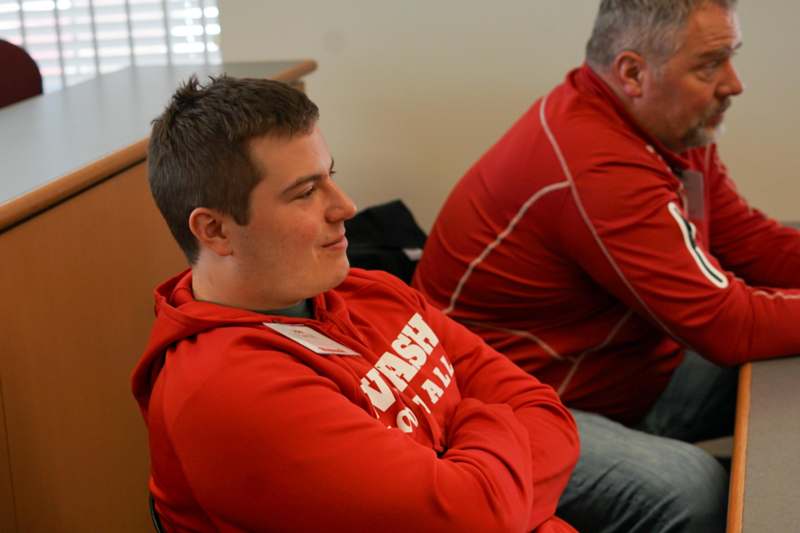 a man in red jacket with his arms crossed