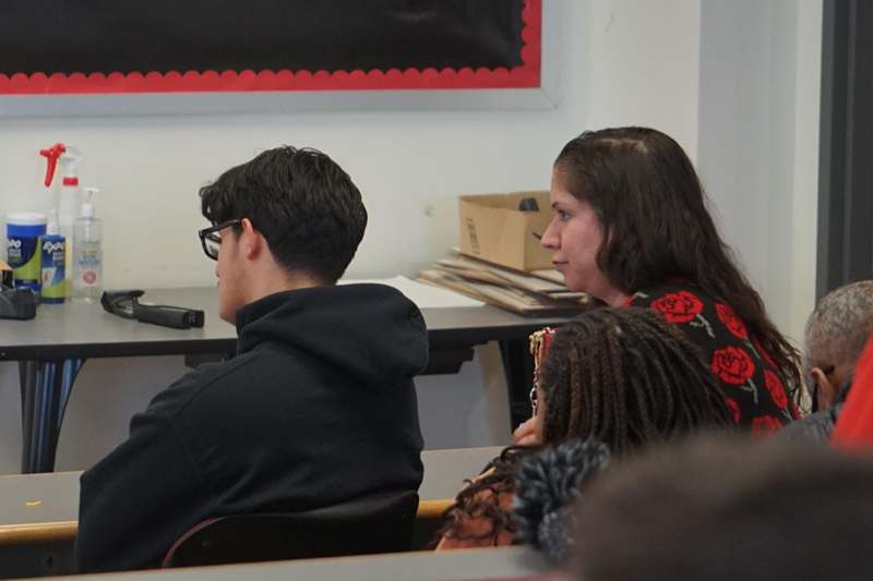 a group of people sitting in a classroom